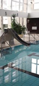 a large swimming pool with a long pipe in the water at BeachPark Sierksdorf in Scharbeutz