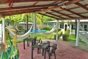 a patio with hammocks and tables and chairs at Casa Libre Guest House in Conchagua +25 photos