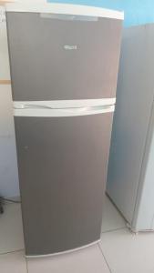 a white refrigerator sitting next to a white freezer at Casa da gamboa in Cairu