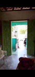 a room with a door open to a living room at Casa da gamboa in Cairu