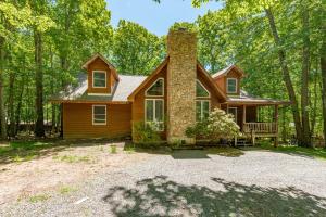 a house in the woods with a bench at Get Your Creek On by Railey Vacations in Swanton