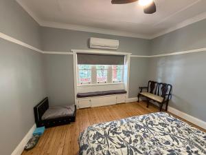 a bedroom with a bed and a window with a radiator at Tily's Place in Parkes
