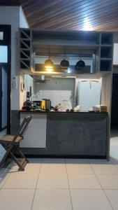 a kitchen with a counter and a refrigerator at Apartamento Rangel in Cairu