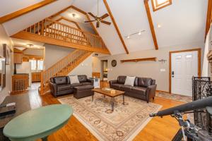 a living room with couches and a table at Get Your Creek On by Railey Vacations in Swanton +137 photos
