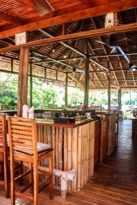 a wooden bar with a wooden chair and a counter at The Hummingbird in Bocas Town