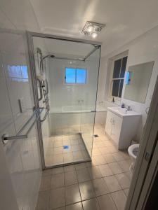 a bathroom with a shower and a toilet and a sink at Tily's Place in Parkes +15 photos