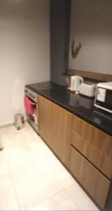 a kitchen with a black counter top in a room at Departamen dos ambientes in Buenos Aires