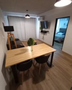 a wooden table and chairs in a living room at Departamen dos ambientes in Buenos Aires