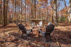 four chairs and a table in the woods at Get Your Creek On by Railey Vacations in Swanton