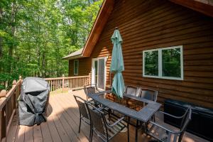 a table with an umbrella on a deck at Get Your Creek On by Railey Vacations in Swanton