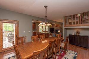 a dining room and kitchen with a wooden table and chairs at Getaway Chalet by Railey Vacations in Oakland