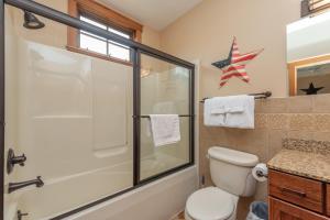 a bathroom with a toilet and a glass shower at Getaway Chalet by Railey Vacations in Oakland