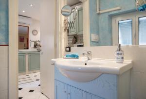 a bathroom with a white sink and a mirror at Romantic Sea View Flat in Genova in Genoa