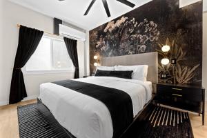 a bedroom with a large bed with a black and white blanket at Hotel Zindel in San Diego