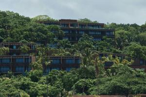 an apartment building in the midst of trees at Siari Riviera Nayarit, a Ritz-Carlton Reserve in El Divisadero