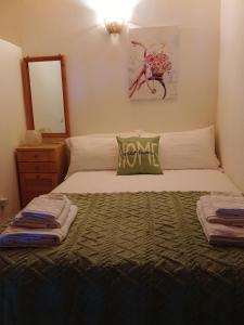 a bedroom with a bed with a green pillow on it at Erbanova in Sila in Camigliatello Silano