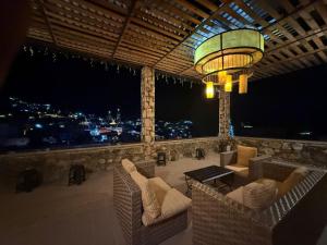 a patio with chairs and a table and a chandelier at Hotel Ruinas Del Real in Real de Catorce