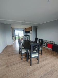 a dining room with a black table and chairs at Triplex con vista hermosa in Salta