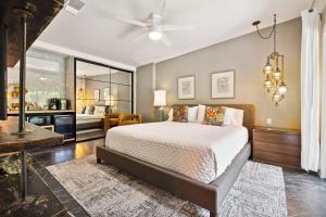 a bedroom with a bed and a living room at Speakeasy Hotel in Palm Springs +117 photos