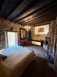 a bedroom with a large bed in a stone building at Hotel Ruinas Del Real in Real de Catorce