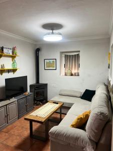 a living room with a couch and a table at La Casita in Ardales