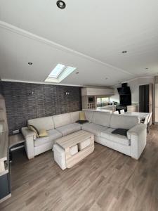 a living room with a couch and a table at RelaxDream in Port Seton +12 photos