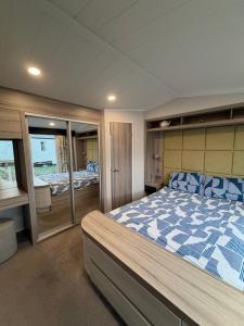 a large bedroom with a bed in a boat at RelaxDream in Port Seton