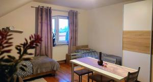 a living room with a dining room table and a window at AzyL25 in Starachowice