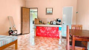 a kitchen with a table and a dining room at Macabuag Apartment in Narra