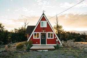 a red house with a pitched roof at The Cozy Owl A-Frame in Jefferson