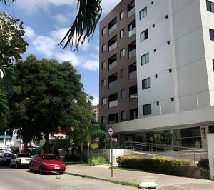 a red car parked in front of a building at Apartamento Completo 608 Monte Fuji, Praia de Cabo Branco in João Pessoa