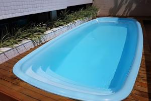 a blue bath tub sitting on a deck with plants at Apartamento Completo 608 Monte Fuji, Praia de Cabo Branco in João Pessoa