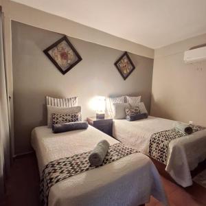 a bedroom with two beds at Hotel Hacienda Entabladero in Entabladero +7 photos