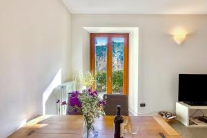 a living room with a table and a window at Lenno Centrale in Lenno