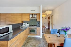 a kitchen with a microwave oven and a table at Lenno Centrale in Lenno