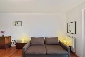 a living room with a couch and a table at Residenza Menaggio - Mimosa in Menaggio