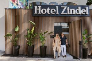 a man and woman standing in front of a hotel ziggurat at Hotel Zindel in San Diego +3 photos