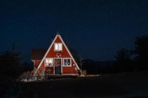 a red house with a starry sky at night at The Cozy Owl A-Frame in Jefferson