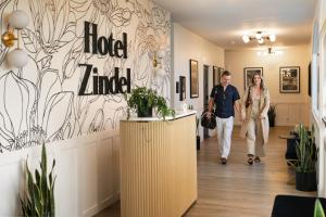 a man and a woman walking down a hallway at Hotel Zindel in San Diego