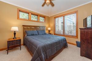 a bedroom with a bed and a ceiling fan at Firefly Cove by Railey Vacations in McHenry +37 photos