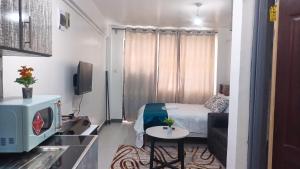 a small room with a bed and a small table at Franliz Apartments in Nairobi