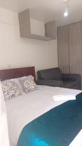 a bedroom with a bed and a couch at Franliz Apartments in Nairobi