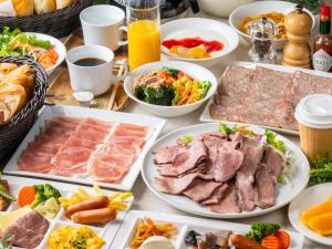 a table with many plates of food on it at APA Hotel Shinjuku Kabukicho Tower in Tokyo
