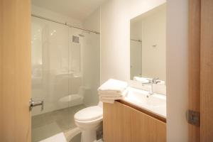 a bathroom with a toilet and a sink and a shower at Hotel Estar in Manizales