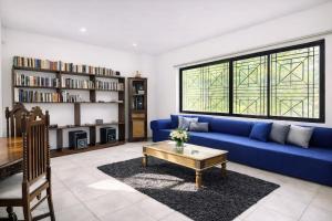 a living room with a blue couch and a coffee table at 519@jamtree in Colombo