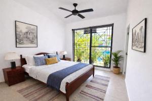 a bedroom with a bed and a ceiling fan at 519@jamtree in Colombo