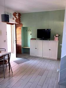 a living room with a flat screen tv on a wall at Appartamento La Corte in Inveruno