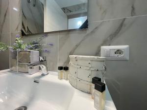 a bathroom with a sink and a mirror at LETIZIA'S HOME Caserta in Caserta +42 photos