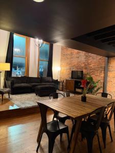 a living room with a wooden table and chairs at The Lofts at 107 in Nashville