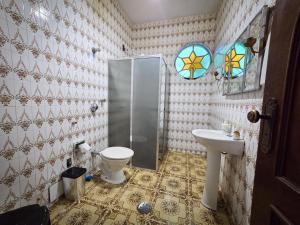 a bathroom with a toilet and a sink at Vila Mariah Hostel in Belo Horizonte +32 photos